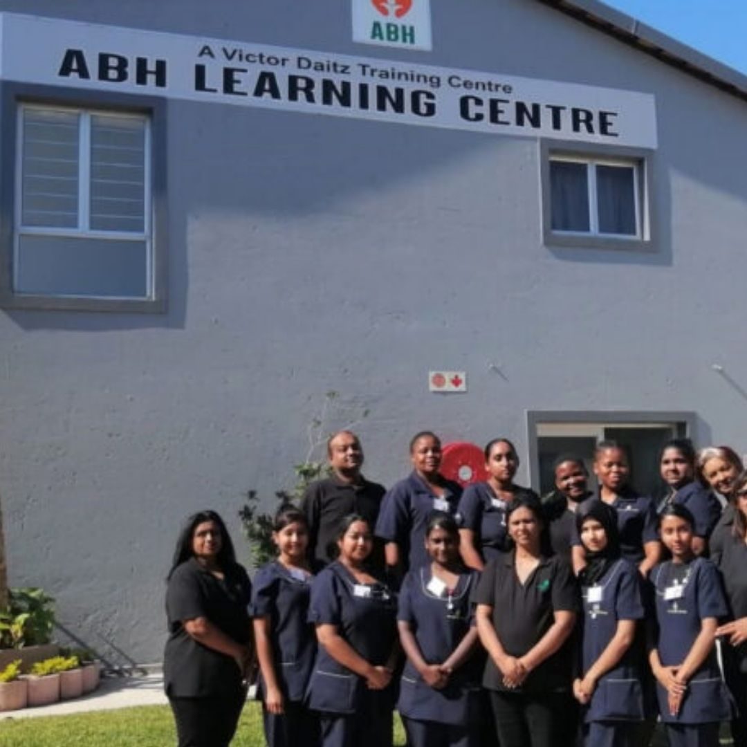 ABH Learning Centre Nursing Students Nursing students in navy uniforms standing in front of the ABH Learning Centre building, a Victor Daitz training centre.