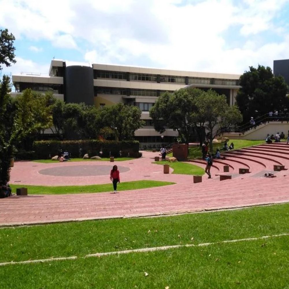 Cape Peninsula University of Technology Campus Plaza Students walk across a brick plaza with amphitheater style steps at Cape Peninsula University of Technology.