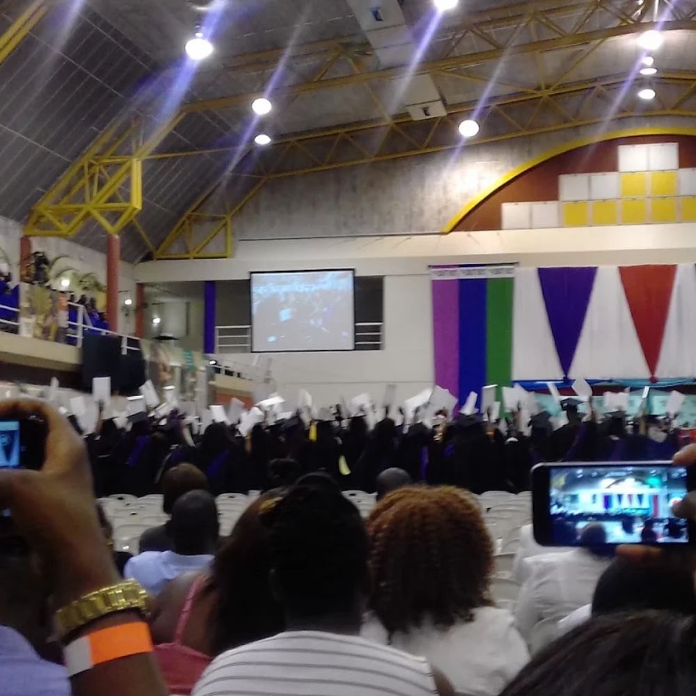 Durban University of Technology Graduation Ceremony Graduates in caps and gowns celebrating at a Durban University of Technology graduation ceremony inside a hall.