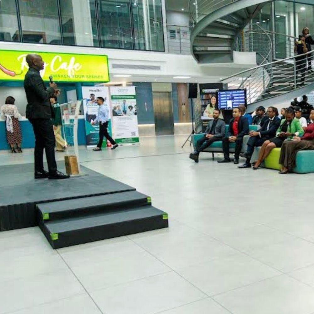 Regenesys Business School Atrium Event A speaker addresses seated guests in the atrium at Regenesys Business School during an event.