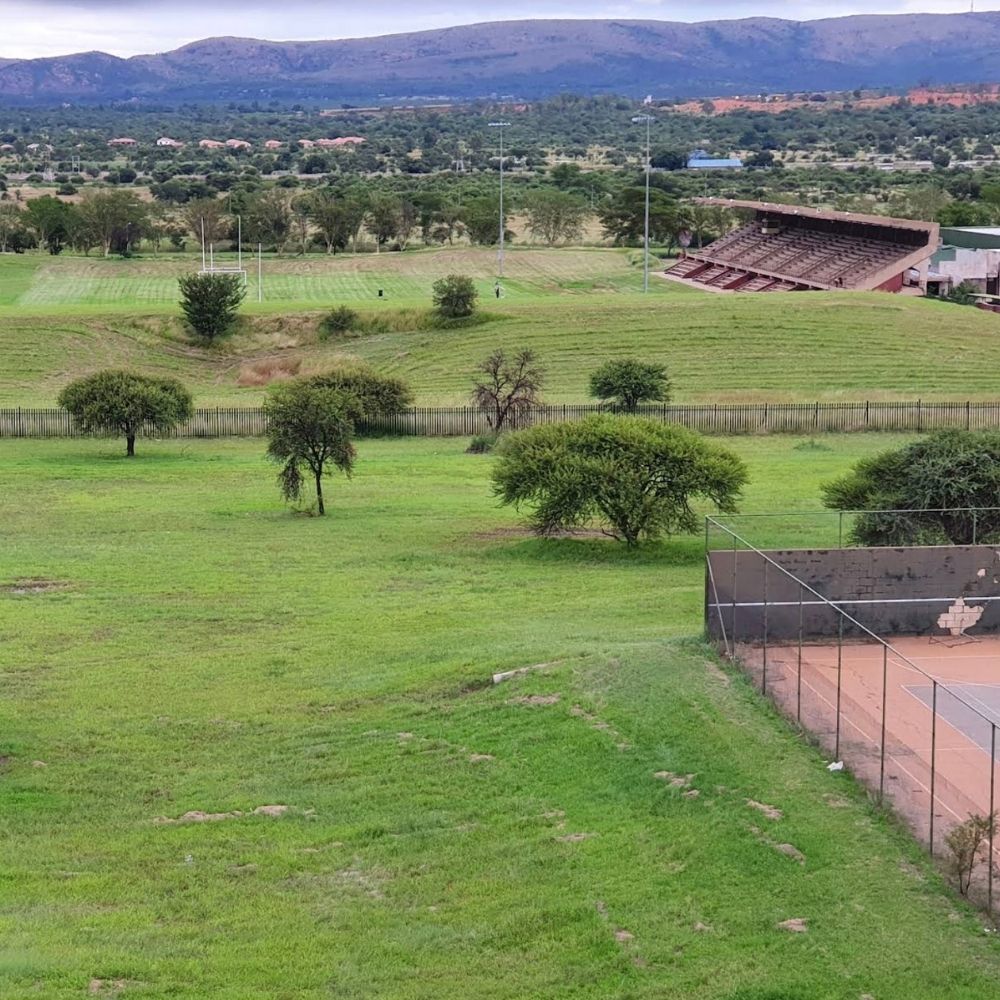 Sports Fields at Sefako Makgatho Health Sciences University The sports fields, grandstand, and tennis court at Sefako Makgatho Health Sciences University, with hills beyond.