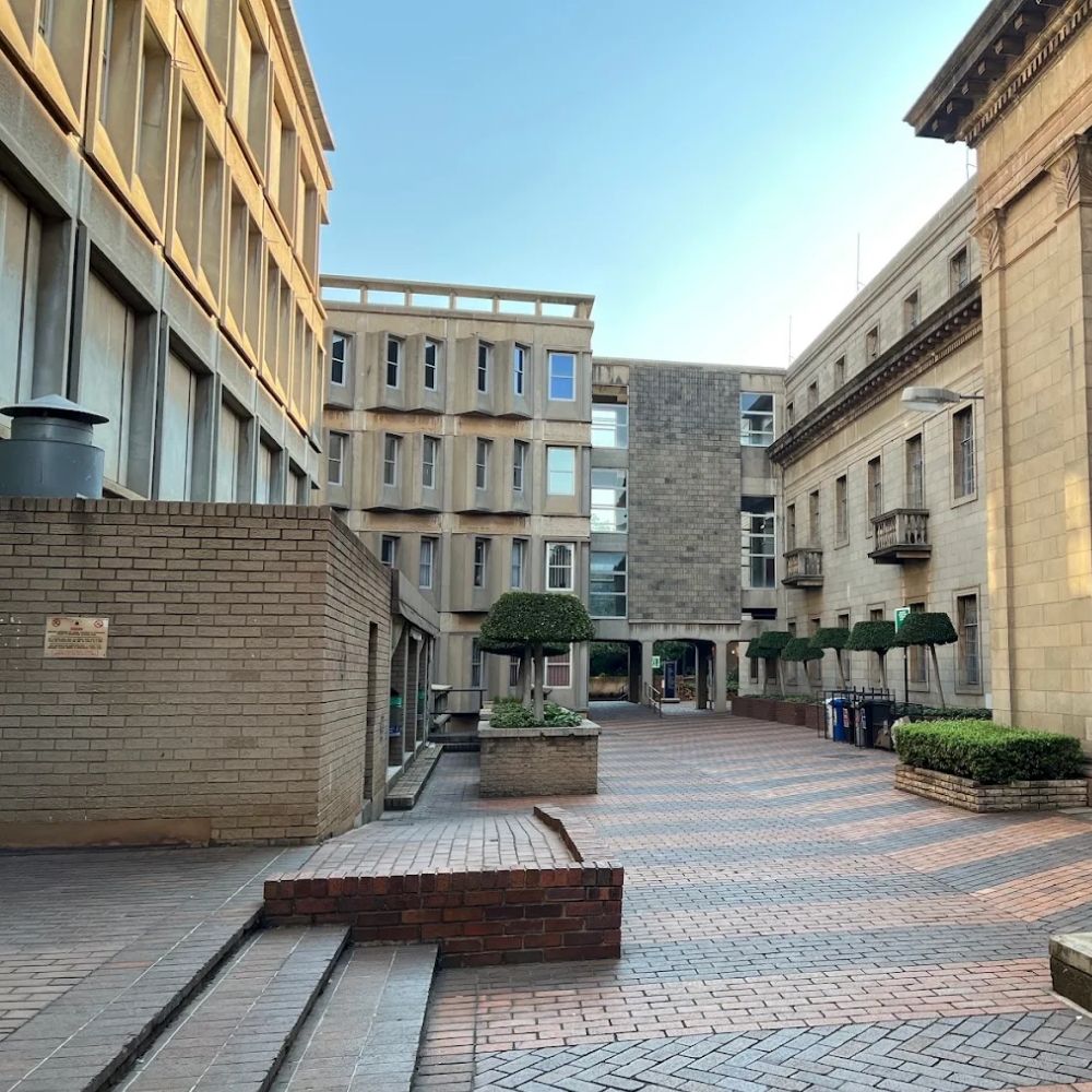 Courtyard Walkway at the University of the Witwatersrand A paved courtyard walkway connects historic and modern buildings at the University of the Witwatersrand.