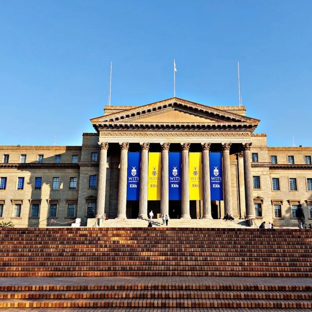 University of the Witwatersrand Great Hall Centenary Banners The columned Great Hall at the University of the Witwatersrand displays blue and gold centenary banners.